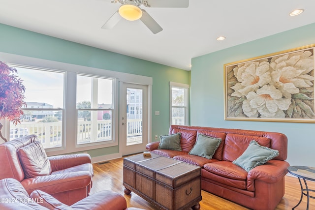 living room featuring ceiling fan and light wood-type flooring