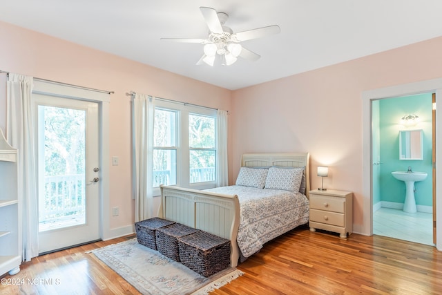 bedroom with light wood-type flooring, ensuite bathroom, access to outside, ceiling fan, and sink