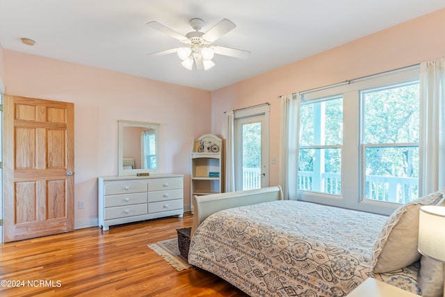 bedroom featuring access to outside, ceiling fan, and light hardwood / wood-style flooring