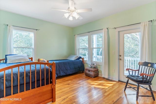 bedroom featuring ceiling fan, light wood-type flooring, access to outside, and multiple windows