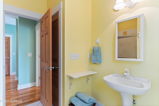 bathroom with hardwood / wood-style flooring and sink