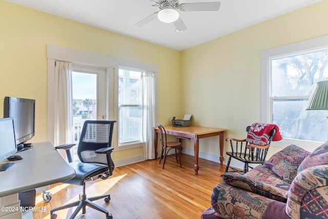 home office featuring ceiling fan and light hardwood / wood-style flooring