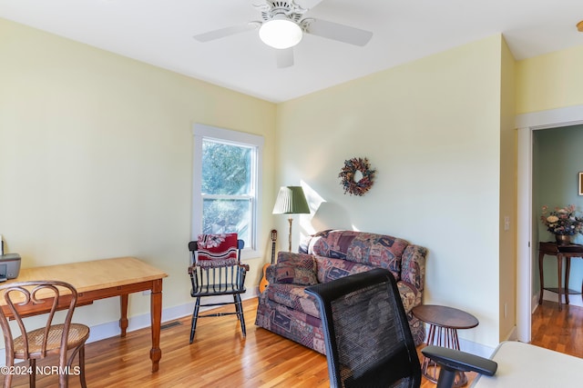 living area with light wood-type flooring and ceiling fan