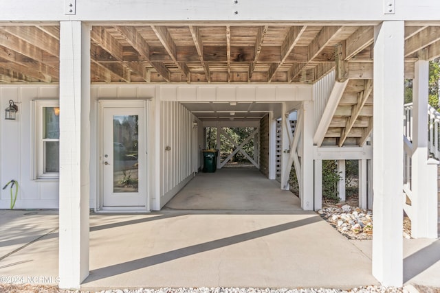 doorway to property featuring a carport