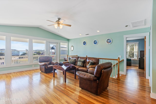 living room featuring a wealth of natural light, light hardwood / wood-style flooring, ceiling fan, and vaulted ceiling