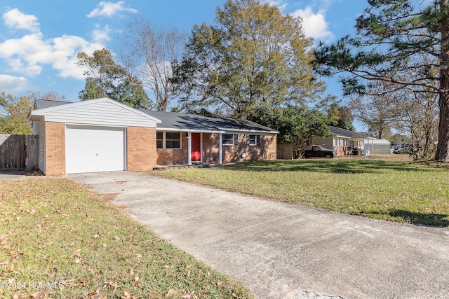 ranch-style house featuring a garage and a front yard