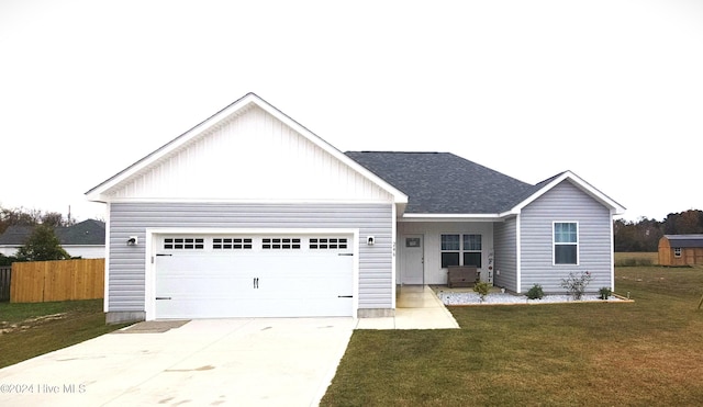 view of front of property featuring a front yard and a garage