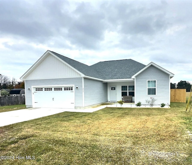 single story home featuring a front lawn and a garage