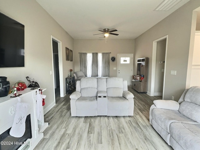 living room featuring light wood-type flooring and ceiling fan