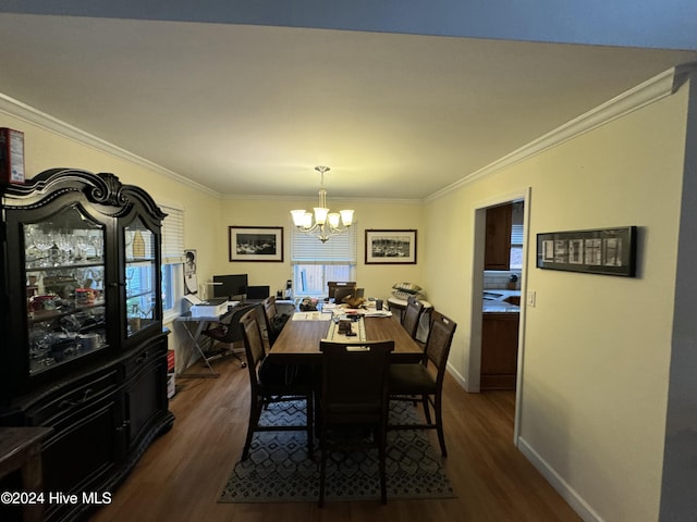 dining room with dark hardwood / wood-style floors, crown molding, and a notable chandelier