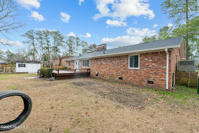 exterior space with a shed, a deck, and a lawn