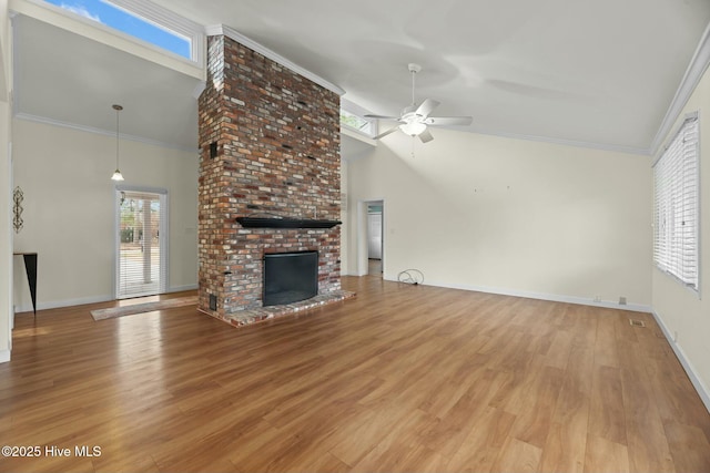 unfurnished living room with ceiling fan, a fireplace, crown molding, and light hardwood / wood-style floors