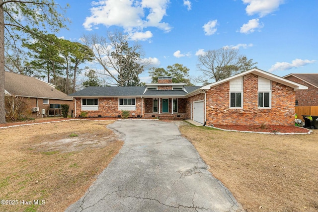 single story home with a front yard and a garage