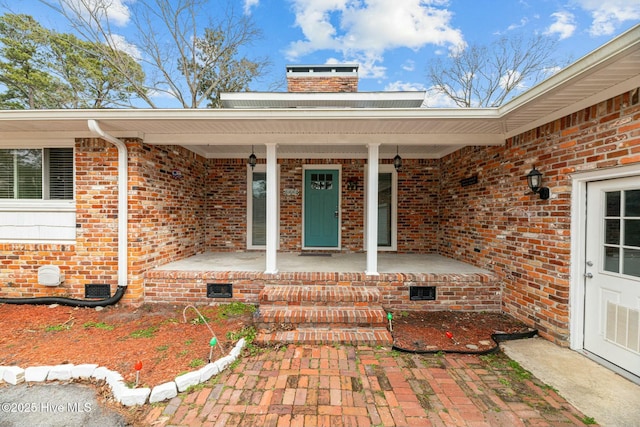 view of exterior entry featuring a porch