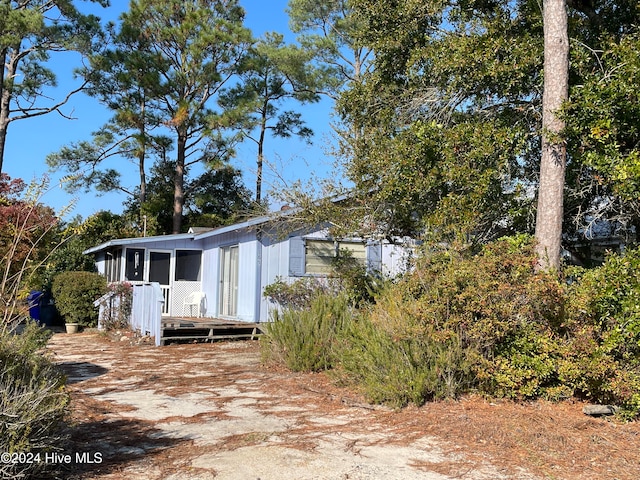 view of side of property featuring a wooden deck