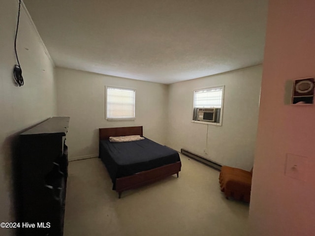 bedroom with cooling unit and a baseboard heating unit