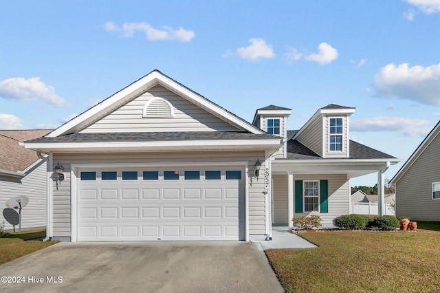 view of front of home with a garage and a front lawn