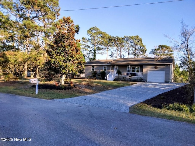 ranch-style house with driveway, a porch, and an attached garage