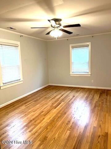 unfurnished room with ceiling fan, wood-type flooring, and crown molding