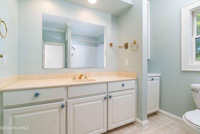 bathroom with vanity, plenty of natural light, tile patterned flooring, and toilet