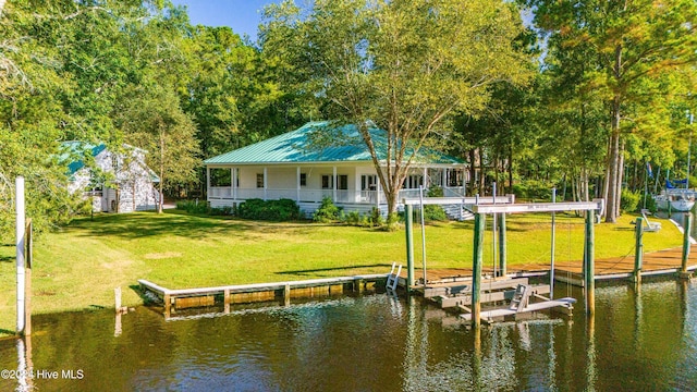 dock area with a lawn and a water view