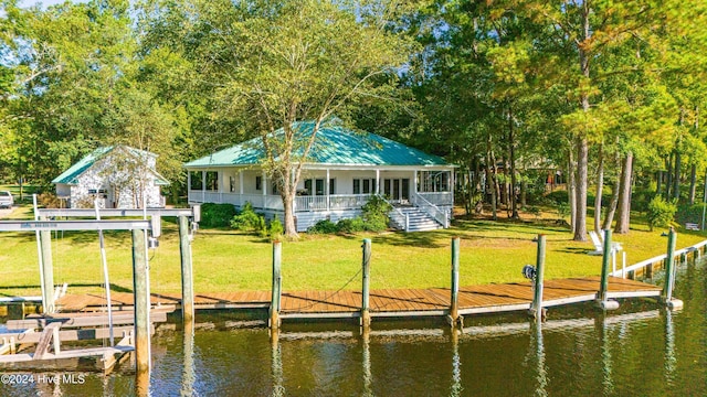 dock area with a lawn and a water view