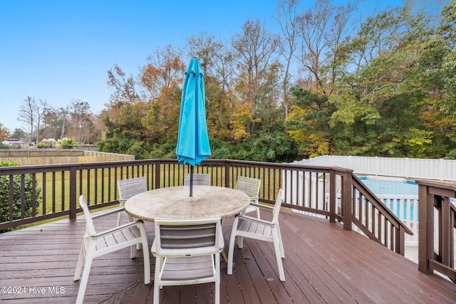 wooden deck with a pool