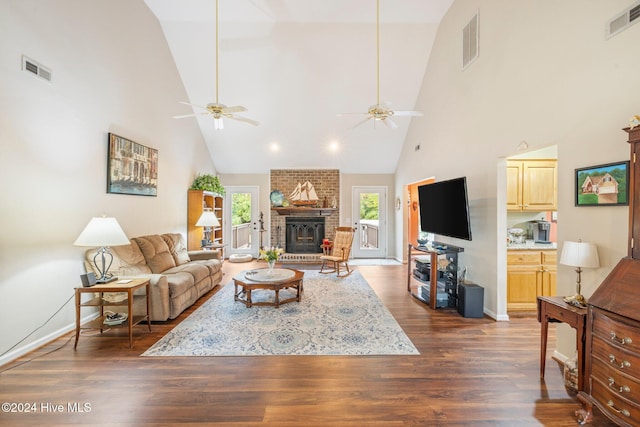 living room featuring ceiling fan, dark wood-type flooring, and high vaulted ceiling