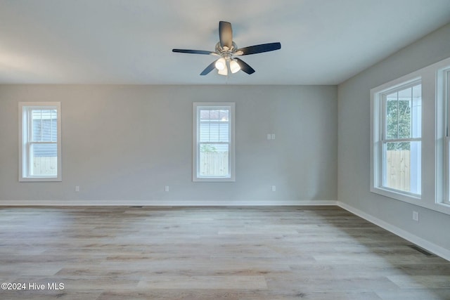 unfurnished room featuring a wealth of natural light and light hardwood / wood-style floors