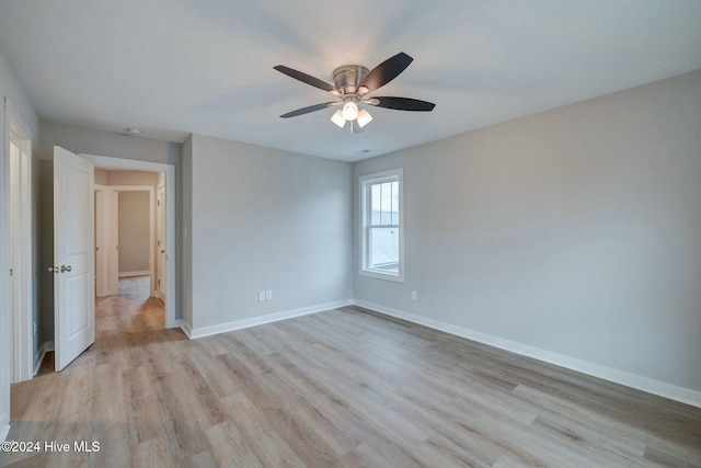 empty room with ceiling fan and light hardwood / wood-style floors