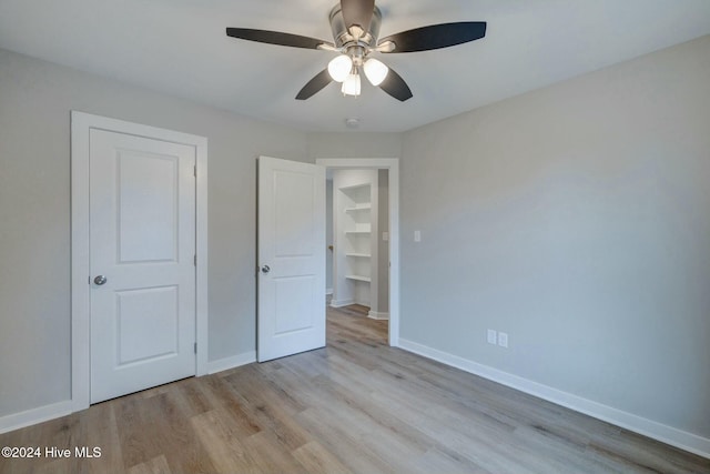 unfurnished bedroom featuring ceiling fan and light wood-type flooring