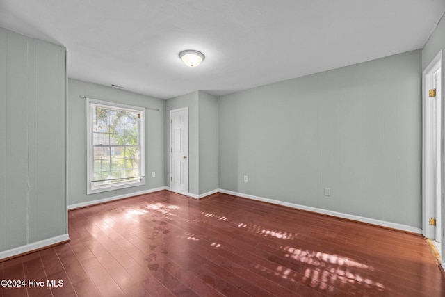 spare room featuring wood-type flooring