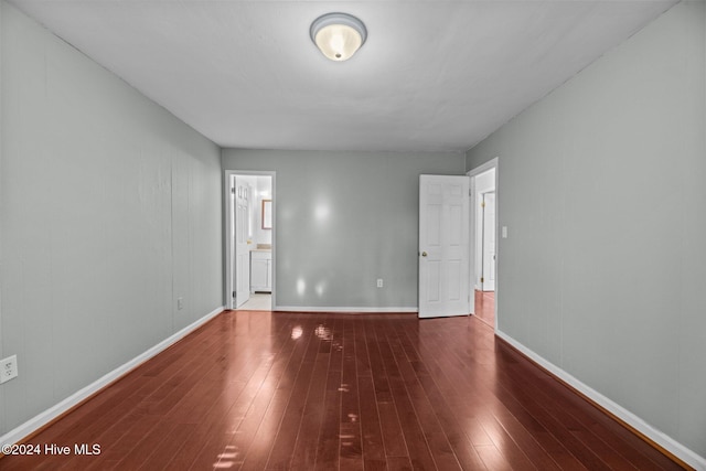 empty room featuring dark wood-type flooring