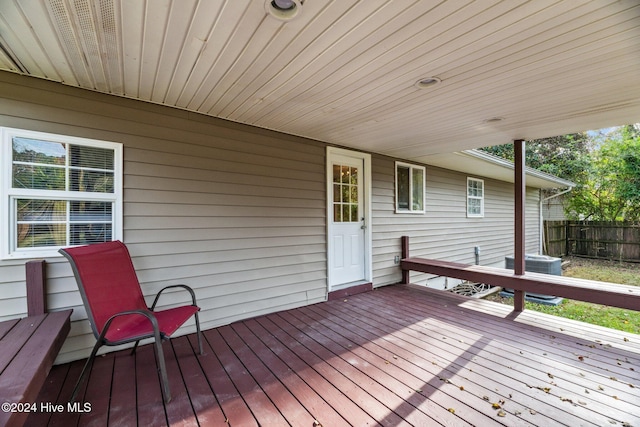 wooden deck featuring central AC unit