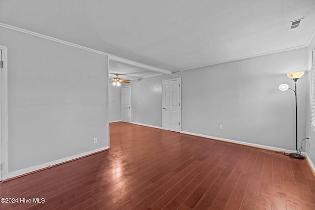 spare room with ceiling fan, beam ceiling, dark hardwood / wood-style flooring, and crown molding