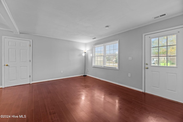 interior space with dark hardwood / wood-style flooring and crown molding