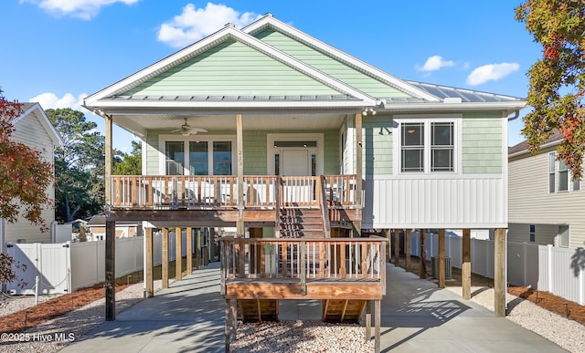 view of front of home featuring a carport, ceiling fan, and a porch