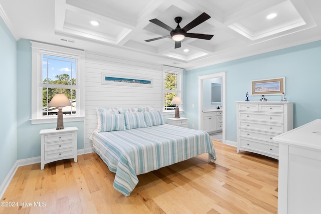 bedroom featuring multiple windows, coffered ceiling, and light wood-type flooring