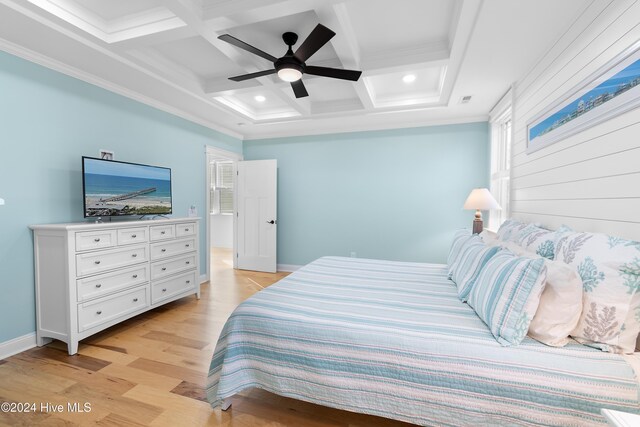 bedroom featuring crown molding, coffered ceiling, light hardwood / wood-style floors, and beamed ceiling