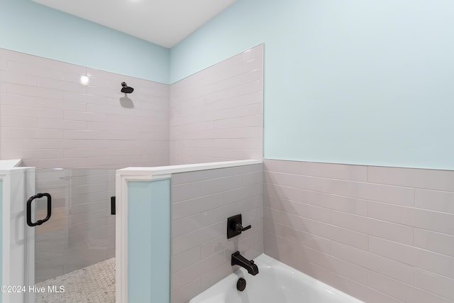 bathroom featuring combined bath / shower with glass door