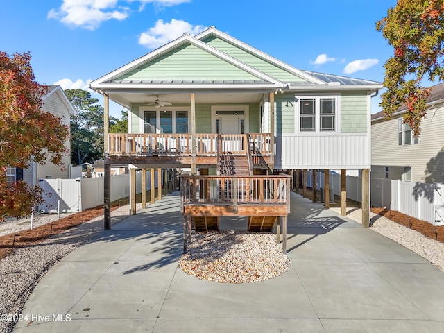 view of front of property featuring a carport, ceiling fan, and a porch