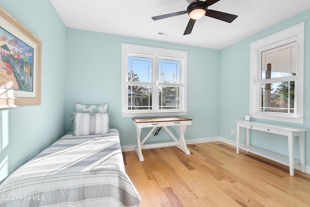 bedroom with ceiling fan and light hardwood / wood-style floors