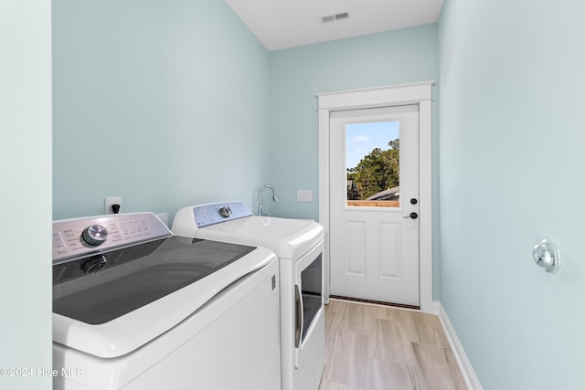 clothes washing area with washing machine and clothes dryer