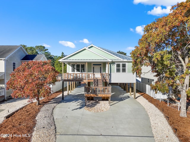 bungalow-style home with a carport and a porch