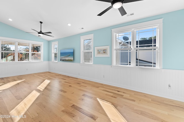 unfurnished room featuring vaulted ceiling, ceiling fan, a healthy amount of sunlight, and light hardwood / wood-style floors