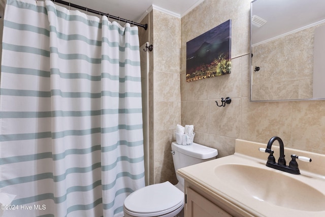 bathroom with vanity, crown molding, toilet, walk in shower, and tile walls