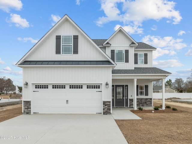 view of front of home featuring concrete driveway, stone siding, roof with shingles, an attached garage, and a porch