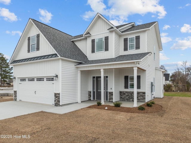 view of front of home featuring a shingled roof, concrete driveway, stone siding, a standing seam roof, and a porch