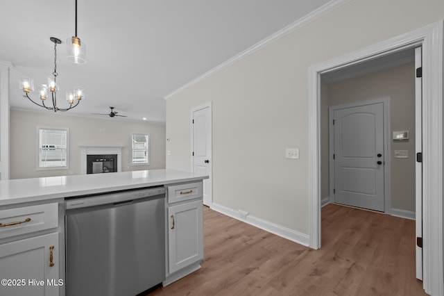 kitchen featuring crown molding, white cabinetry, stainless steel dishwasher, light wood-type flooring, and pendant lighting