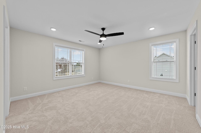 unfurnished room featuring carpet flooring, plenty of natural light, baseboards, and ceiling fan